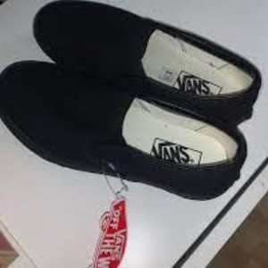 All black slip on Vans